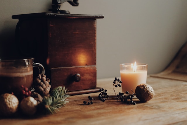 How Urn Options Offer Beauty and Comfort Lit candle beside rustic decor on wooden table, symbolizing remembrance, cremation services Northern Cambria, PA
